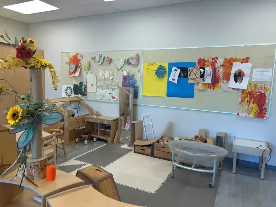 Children's paintings and drawings pinned across the Butterfly Room display boards
